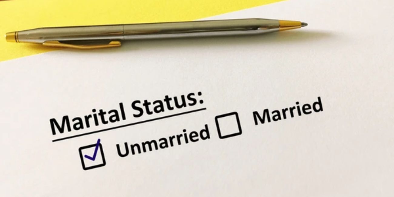 Pen selecting "married" status on a legal form, symbolizing the automatic revocation of a previous will upon marriage under the malaysian wills act.