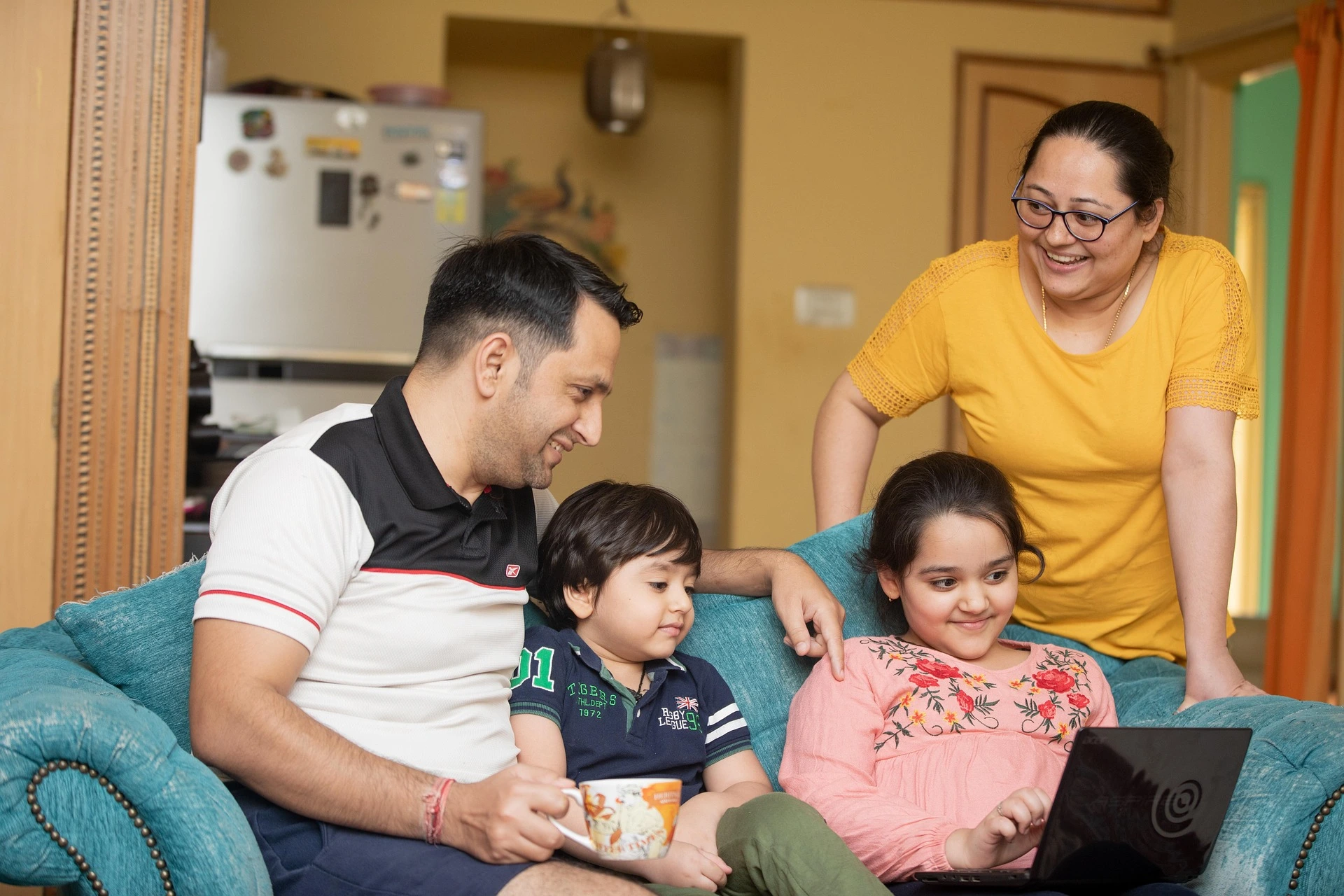 Multi-generational family enjoying time in their living room, symbolizing household security and harmony preserved by a cnb amanah property trust.