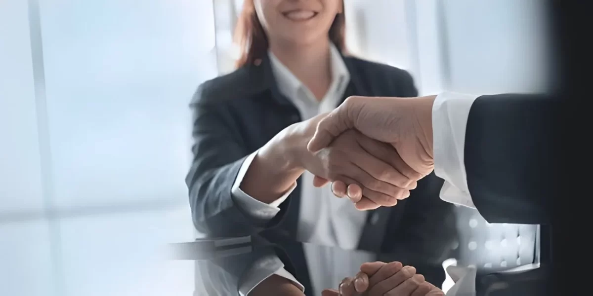 Securing business agreements with corporate trusts - cnb amanah - will writing & trust services in malaysia | cnb amanah bhd A close-up of a professional handshake between business partners, symbolizing the formal security and trust established through a corporate trust agreement in malaysia.