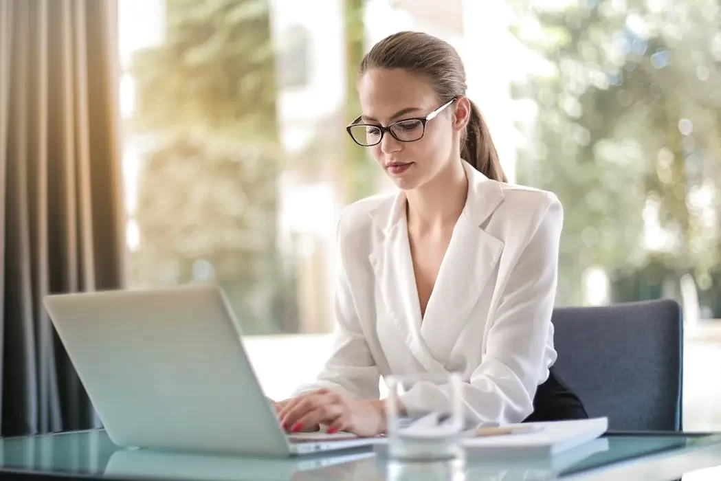 A professional corporate trustee working diligently on a laptop, representing the efficient administration, record-keeping, and compliance checks provided by a trust company in malaysia.