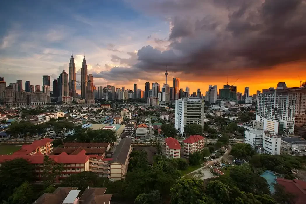 A panoramic view of the kuala lumpur skyline at sunset, symbolizing the diverse asset portfolios that can be protected through a hybrid trust in malaysia.